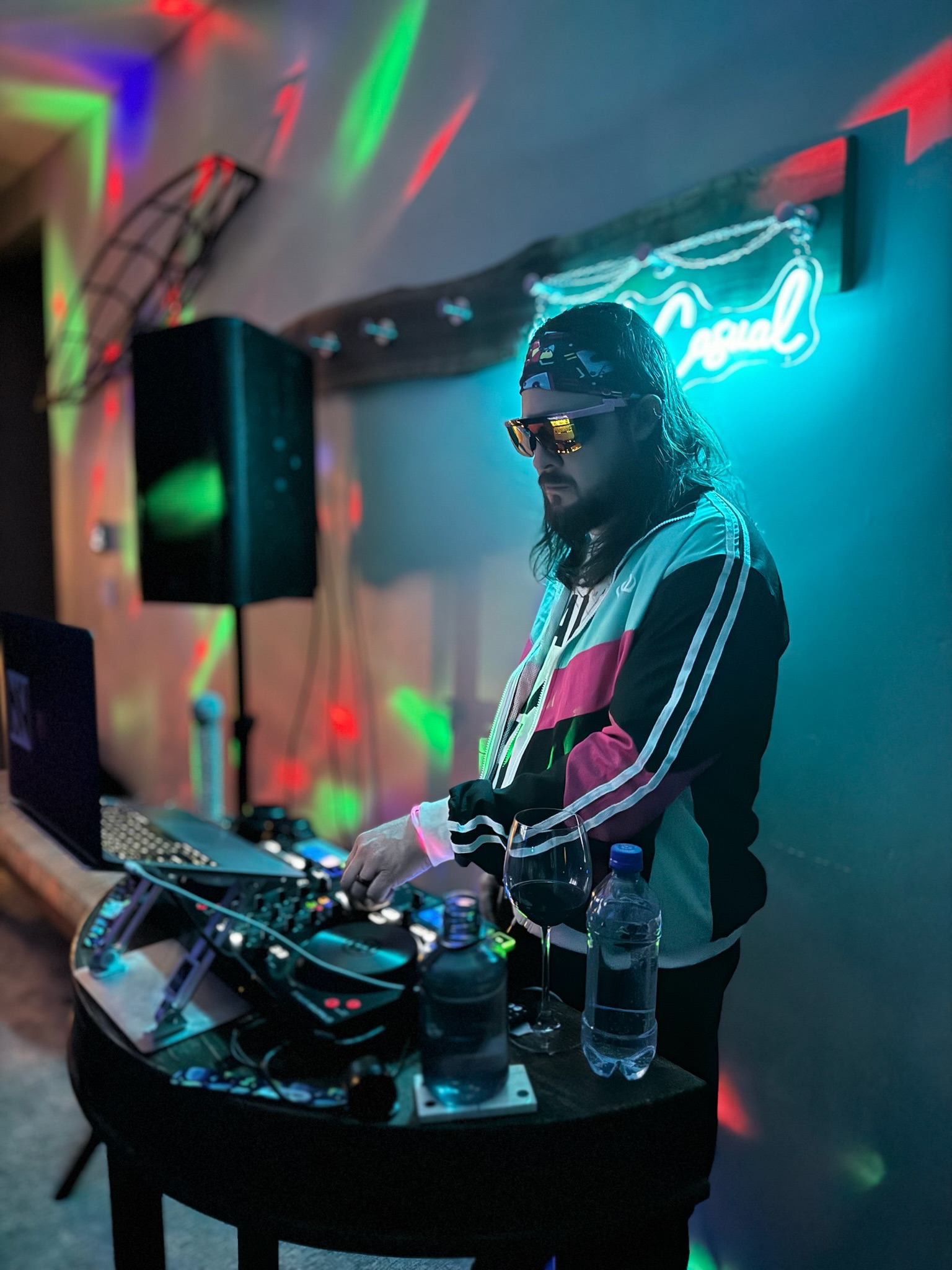 DJ NickNak mixing at a neon-lit party